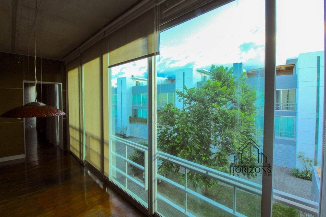 Apartamento con rooftop privado en Guachipelín - sala con ventanal